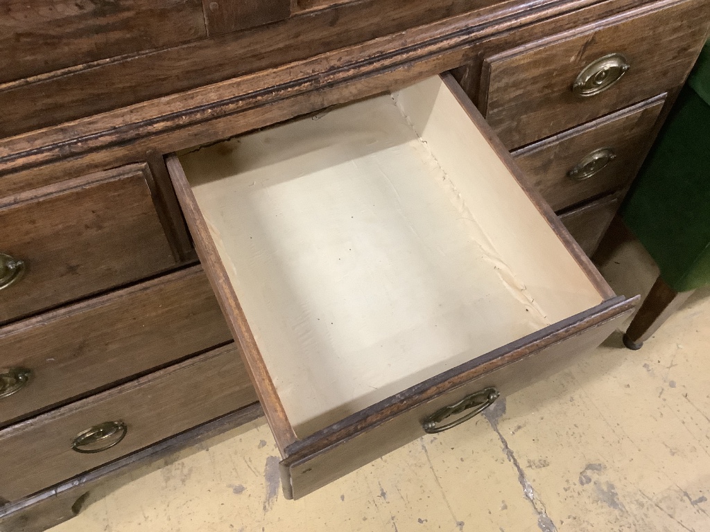 A mid 18th century oak two part bow fronted Dower chest / linen press, with doors enclosing shelves and six drawers, width 121cm